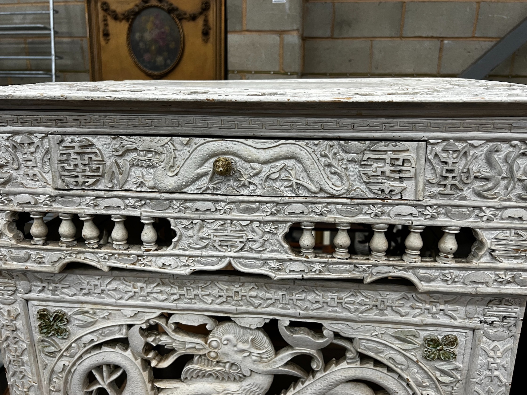 An early 20th century Chinese carved side table, width 75cm depth 56cm height 67cm (later painted)